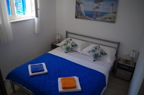 a bedroom with a blue and white bed with a tray on it at Apartments by the sea Slatine, Ciovo - 14158 in Slatine