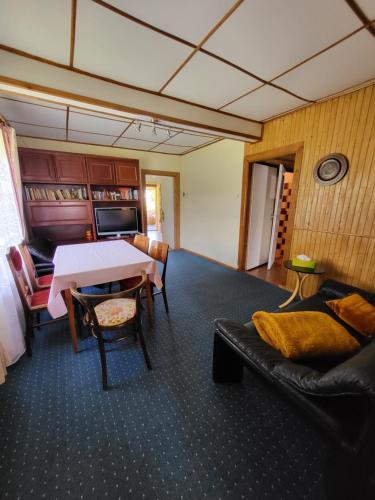 a living room with a table and a couch at Białowieża 131 in Białowieża
