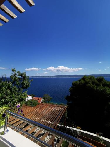 a view of the ocean from a balcony at Apartments by the sea Mimice, Omis - 14230 in Mimice