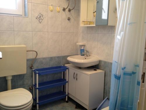 y baño con aseo y lavamanos. en Family friendly apartments with a swimming pool Razanj, Rogoznica - 14232 en Rogoznica