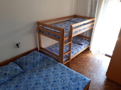 a bedroom with two bunk beds in a room at Seaside secluded apartments Cove Vele Gacice, Hvar - 14255 in Bogomolje