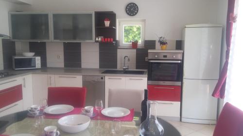 a kitchen with a table and a white refrigerator at Apartment Marina 14258a in Marina
