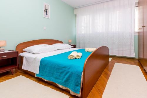 a bedroom with a bed with towels on it at Apartments with a parking space Omis - 14290 in Omiš