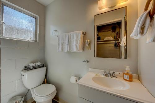 a white bathroom with a toilet and a sink at Pine Tree Place - Unit 1 in South Lake Tahoe