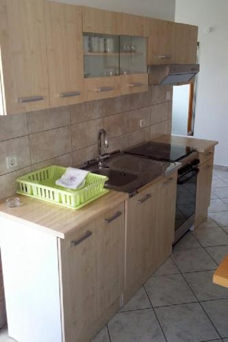 a kitchen with a sink and a counter top at Apartments by the sea Martinscica, Cres - 14334 in Martinšćica