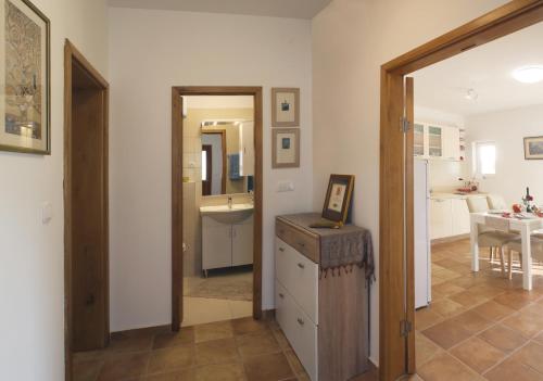 a room with a bathroom and a kitchen with a table at Apartments by the sea Razanj, Rogoznica - 14357 in Rogoznica