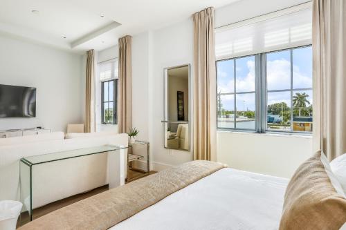 a bedroom with two beds and a window at SoCe Flats 209 in Naples