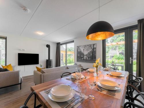 a dining room and living room with a table and chairs at Holiday Home in Lochem with Garden View in Lochem
