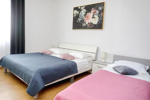 sypialnia z 2 łóżkami i zdjęciem na ścianie w obiekcie Apartments with a parking space Bibinje, Zadar - 14436 w Bibinje