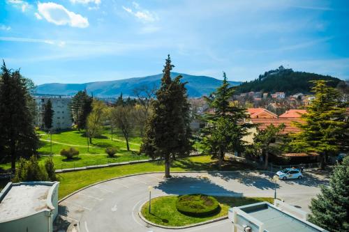 a view of a park with trees and buildings at Rooms with a parking space Sinj, Zagora - 14466 in Sinj