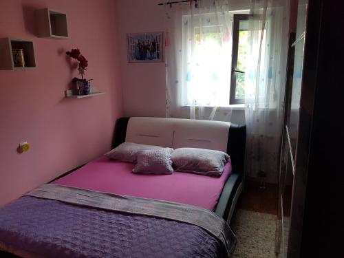a bed with two pillows on it in a room at Apartments by the sea Zavalatica, Korcula - 14498 in Zavalatica