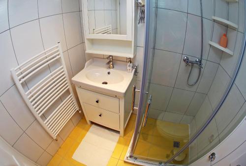 a small bathroom with a sink and a shower at Apartments with WiFi Zadar - 14529 in Zadar