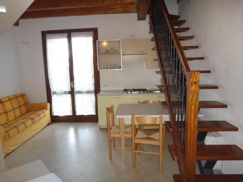 a kitchen and dining room with a table and a staircase at Agriturismo San Valentino in Castellarano