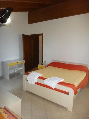 a bedroom with a bed and a desk in it at Agriturismo San Valentino in Castellarano