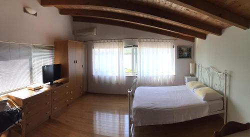 ein Schlafzimmer mit einem Bett und einem TV in der Unterkunft Apartments by the sea Tisno, Murter - 14346 in Tisno