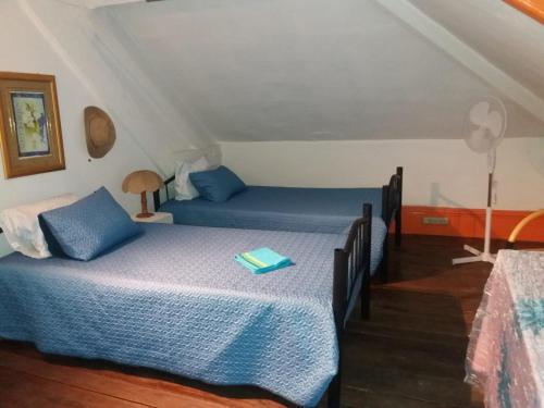 a bedroom with a bed with a book on it at Casa dragão in Porto