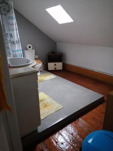 an attic room with a sink and a toilet at Casa dragão in Porto