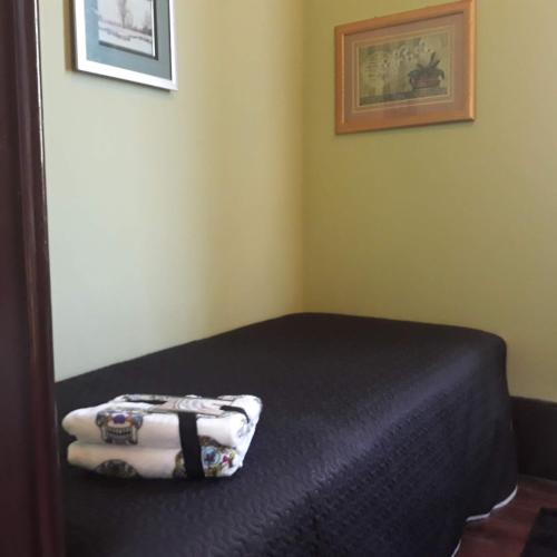 a bedroom with a bed with a blanket and a mirror at Casa dragão in Porto