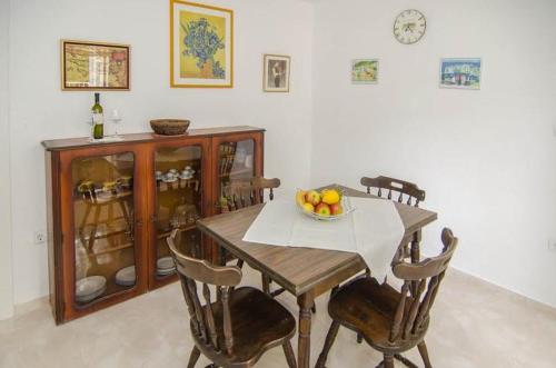 a dining room table with a bowl of fruit on it at Seaside holiday house Trstenik, Peljesac - 16309 in Trstenik