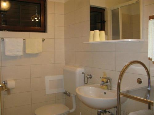 a bathroom with a toilet and a sink at Apartments with a parking space Palit, Rab - 16356 in Mundanije