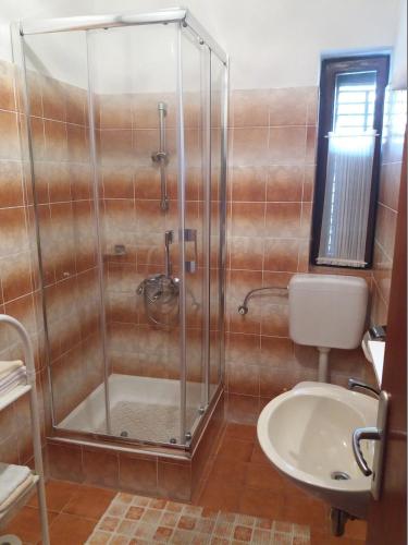 a bathroom with a shower and a toilet and a sink at Apartments with parking space Banjol, Rab - 16334 in Rab
