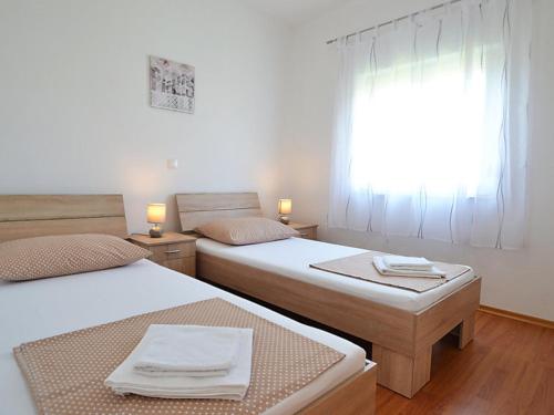 - 2 lits dans une petite chambre avec fenêtre dans l'établissement Holiday house with a parking space Sukosan, Zadar - 16398, à Sukošan