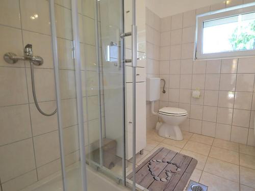 La salle de bains est pourvue d'une douche et de toilettes. dans l'établissement Holiday house with a parking space Sukosan, Zadar - 16398, à Sukošan