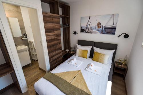 a bedroom with a bed with two towels on it at Apartments with WiFi Pirovac, Sibenik - 16443 in Pirovac