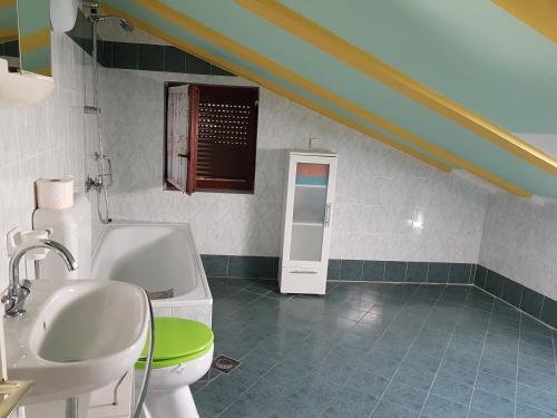 a bathroom with a sink and a toilet at Apartments with a parking space Tar, Porec - 16475 in Tar