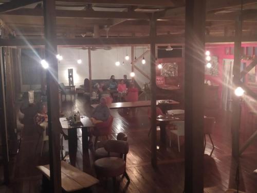 a group of people sitting at tables in a restaurant at Villa F&B in Bocas del Toro