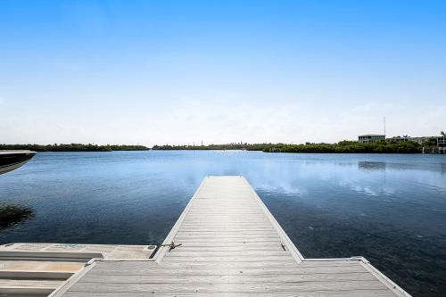 a dock on a large body of water with a boat at Sunset Bay in Key West