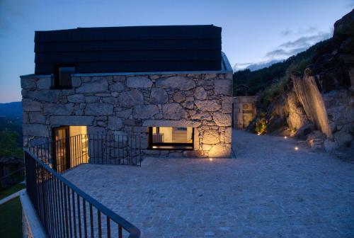 a stone house with a staircase leading up to it at Varanda de Sistelo in Sistelo