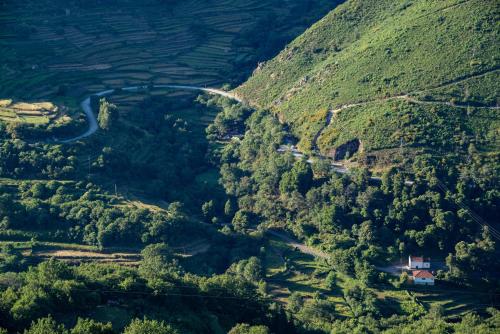 an aerial view of a mountain valley with a road at Varanda de Sistelo in Sistelo