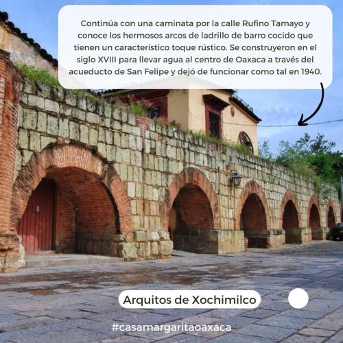 a stone wall with arches on top of it at Casa Margarita Oaxaca in Oaxaca City
