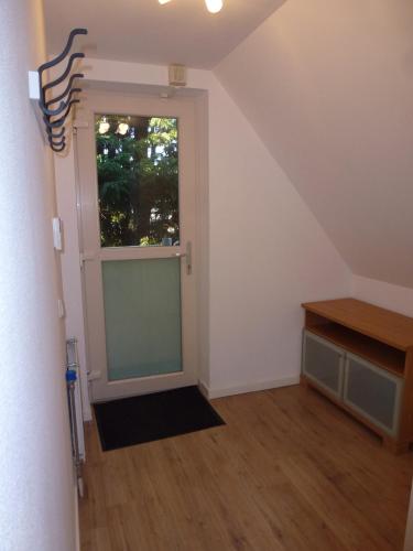 an attic room with a door and a window at Schiphol Apartments in Aalsmeer