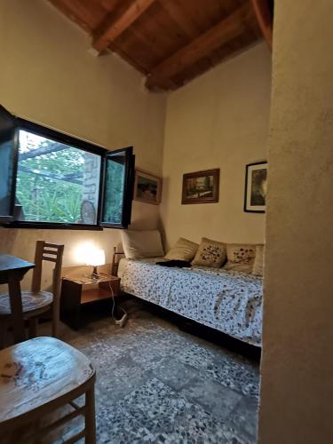 a bedroom with a bed and a window at Trulli Vittoria in Putignano