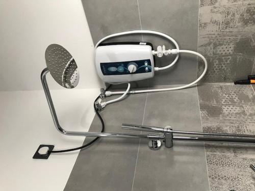 a hair dryer attached to a wall in a bathroom at Happy Homes in Kiribathgoda