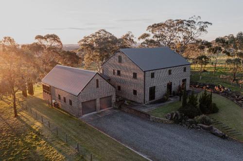 an aerial view of a large white house at 47 WOOLSHED ROAD - Adelaide Hills rural retreat in Mount Torrens