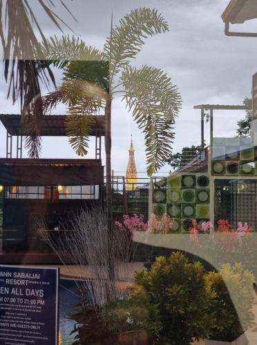 a view of a building with a clock tower in the background at Baan Sabaijai Resort in That Phanom