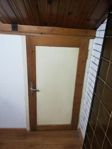 two doors in a room with wooden ceilings at Guest Room Asparuh in Troyan