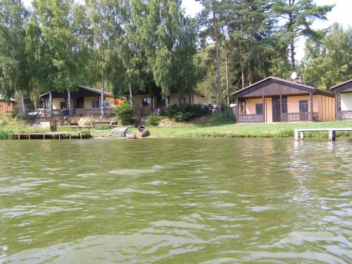 a man sitting in the middle of a body of water at Rekreační chaty Malý Ratmírov in Malý Ratmírov
