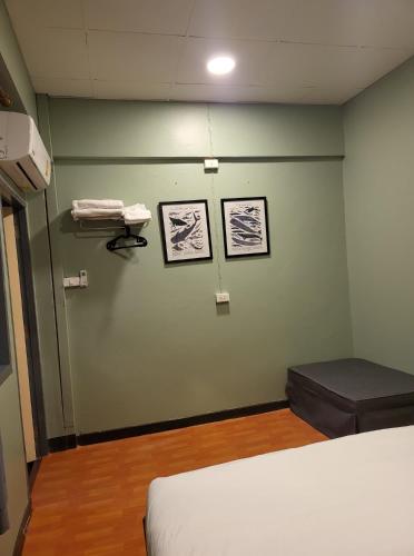 a hospital room with a bed and a phone on a wall at Achcha hotel - itsaraphap MRT station - Wat Arun in Bangkok