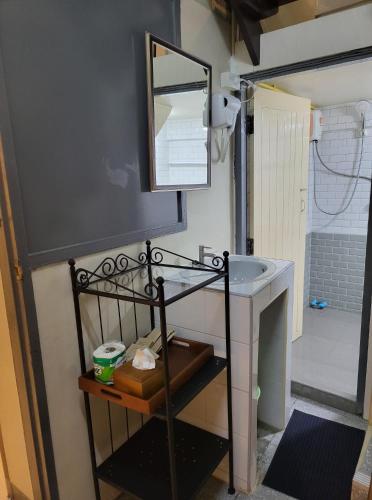 a bathroom with a sink and a mirror at Achcha hotel - itsaraphap MRT station - Wat Arun in Bangkok