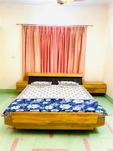a bedroom with a bed in front of a curtain at JAWAHAR VILLA - 2BHK - City Centre in Jodhpur