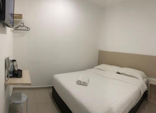 Łóżko lub łóżka w pokoju w obiekcie M Design Hotel@KLIA,Sepang