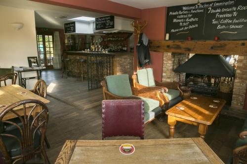 a room with chairs and tables and a bar at The Inn at Emmington in Chinnor