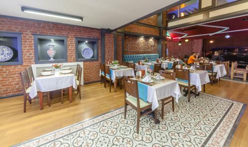 a restaurant with tables and chairs and a brick wall at Viva Deluxe Hotel in Istanbul