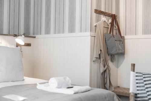 a bedroom with a bed with towels on it at Naya Retreat & Hotell in Mörbylånga