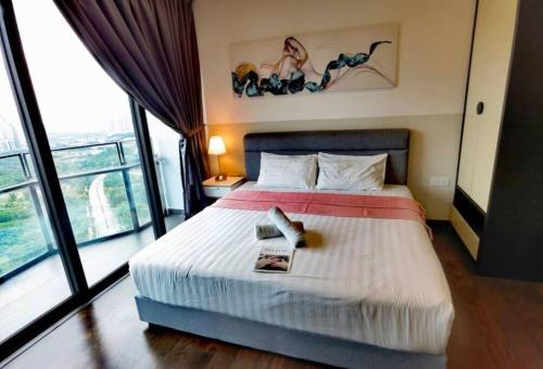 a bedroom with a bed with a book on it at Almas Suite바다 전망 무지 100mbps 넷플릭스스텔라 국제학교까지 도보 2분 in Nusajaya