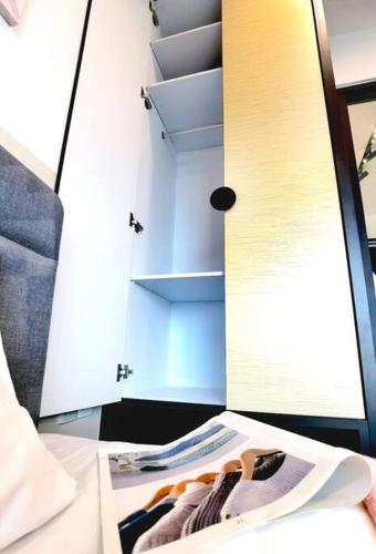 a magazine sitting on a table in front of a mirror at Almas Suite바다 전망 무지 100mbps 넷플릭스스텔라 국제학교까지 도보 2분 in Nusajaya